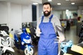 Worker helps choose the motorbikes Royalty Free Stock Photo