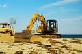 A worker helps replenish the beach