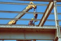 Worker high above dissembling metal structure 4