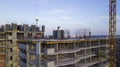 Workers on a high-rise building in the evening clog the formwork for pouring concrete. Royalty Free Stock Photo