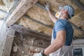 Worker in His 30s Replacing Old Attic Mineral Wool Insulation Royalty Free Stock Photo
