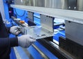 Worker hold the metal sheet work with the CNC hydraulic press brake machine Royalty Free Stock Photo