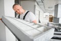 Worker holding air filter for installing in the office ventilation system. Purity of the air concept. Royalty Free Stock Photo