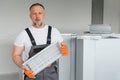 Worker holding air filter for installing in the office ventilation system. Purity of the air concept. Royalty Free Stock Photo