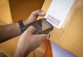 Worker holding barcode scanner scanning red laser on parcel box. Computer tools for warehouse inventory management.