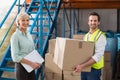 Worker holding box with manager holding clipboard Royalty Free Stock Photo