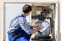 Worker Inspecting Water Pump And Pipes Royalty Free Stock Photo