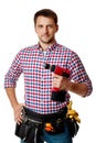 Worker holding cordless screwdriver. handyman wearing tool belt Royalty Free Stock Photo