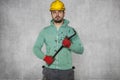 Worker holding a crowbar in his hand, confident attitude