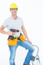 Worker holding drill machine on step ladder Royalty Free Stock Photo