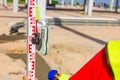 Worker is holding leveling rod to measuring level on construction site Royalty Free Stock Photo