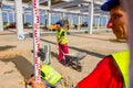 Worker is holding leveling rod to measuring level on construction site Royalty Free Stock Photo