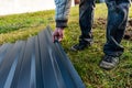 Worker holding metal sheet on grass background Royalty Free Stock Photo