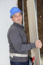 worker holding plywood at construction site Royalty Free Stock Photo