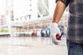 Worker is holding red walky talky by the right hand that wearing