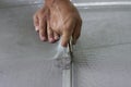 Worker holding a wheel tool to install a aluminum mosquito net wire mesh screen this is to be attached to the window of th Royalty Free Stock Photo