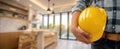 The worker holding a yellow helmet in a beautifully designed modern interior. AI generated image Royalty Free Stock Photo