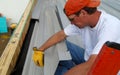Worker holds aluminum sheets