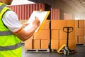 Worker Holds a Clipboard Checking the Loading Package Boxes at Distribution Warehouse. Warehouse Logistics Transport Royalty Free Stock Photo