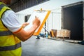 Worker Holds a Clipboard Checking the Loading Package Boxes at Distribution Warehouse. Supplies Warehouse Shipping. Royalty Free Stock Photo