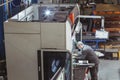 Worker holds a part in a CNC bending machine