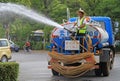 Worker is hosing the street in Lijiang, China Royalty Free Stock Photo