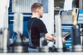 Worker in industrial workshop programming a cnc lathe Royalty Free Stock Photo