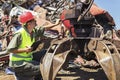 Worker inspect crane on junkyard.