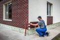 Worker instaling Clinker brick. Clinker thermal panels for finishing the facade of the house. Tiles for outdoor decoration