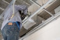 Worker install air ventilation duct pipes on ceiling Royalty Free Stock Photo