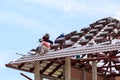 Worker install roof tile for new house