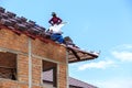 Worker install roof tile for new house