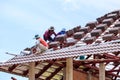 Worker install roof tile for new house