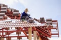 Worker install roof tile for new house