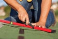 Worker installing bitumen roof shingles