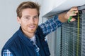 Worker installing blind on window Royalty Free Stock Photo