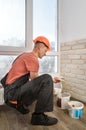 The worker is installing brick tiles on the wall Royalty Free Stock Photo