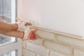 A worker is installing brick tiles on the wall Royalty Free Stock Photo