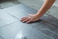 Worker installing ceramic floor tiles Royalty Free Stock Photo