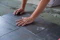 Worker installing ceramic floor tiles Royalty Free Stock Photo