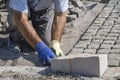 Worker installing granite cubes 2