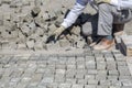 Worker installing granite cubes