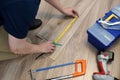 Worker installing laminate flooring. Renovation of home concept.