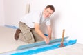 Worker installing a laminated flooring