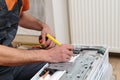 Worker installing a new air conditioner in the apartment. Professional technician maintaining modern air conditioner indoors