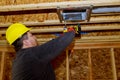 Worker installing air conditioner vents in new home construction Royalty Free Stock Photo