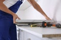 Worker installing new countertop in kitchen Royalty Free Stock Photo