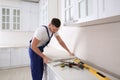 Worker installing new countertop in kitchen Royalty Free Stock Photo