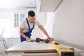 Worker installing new countertop in kitchen Royalty Free Stock Photo