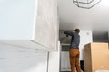 Worker installing new countertop in modern kitchen Royalty Free Stock Photo